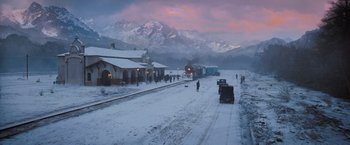Movie still from “Murder on the Orient Express” (2017), directed by Kenneth Branagh – A train traveling down train tracks next to snow covered ground; Extreme Wide shot, High angle