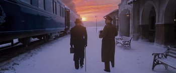 Movie still from “Murder on the Orient Express” (2017), directed by Kenneth Branagh – Two men are standing in the snow near a train; Wide shot, Low angle