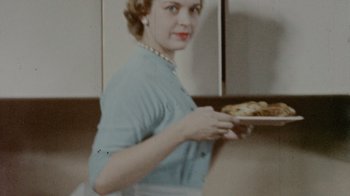 Movie still from “My Name Is Pauli Murray” (2021), directed by Betsy West – A woman holding a plate of food in a kitchen; Close Up shot, Low angle