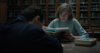 Movie still from “My Policeman” (2022), directed by Michael Grandage – A woman reading a book to a young boy; Medium shot, Over the shoulder angle