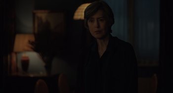 Movie still from “My Policeman” (2022), directed by Michael Grandage – A woman standing in the dark in a room; Close Up shot, Over the shoulder angle