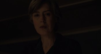 Movie still from “My Policeman” (2022), directed by Michael Grandage – A woman with short blonde hair wearing a black shirt; Close Up shot, Low angle