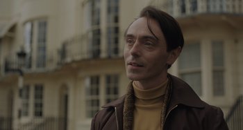 Movie still from “My Policeman” (2022), directed by Michael Grandage – A person wearing a brown jacket; Close Up shot, Low angle