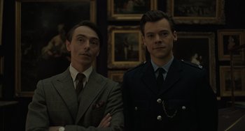 Movie still from “My Policeman” (2022), directed by Michael Grandage – A couple of men standing next to each other in a room; Close Up shot, Over the shoulder angle