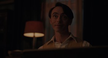 Movie still from “My Policeman” (2022), directed by Michael Grandage – A man is looking at the reflection of himself in a mirror; Close Up shot, Low angle