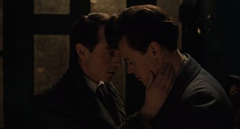 Movie still from “My Policeman” (2022), directed by Michael Grandage – A couple of men standing next to one another; Close Up shot, Low angle