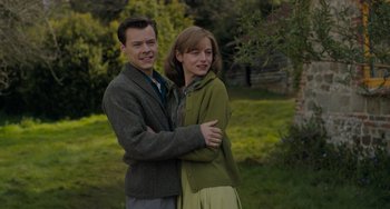 Movie still from “My Policeman” (2022), directed by Michael Grandage – A man and a woman standing next to each other in a field; Medium shot, Over the shoulder angle