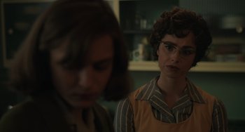 Movie still from “My Policeman” (2022), directed by Michael Grandage – Two people in a kitchen looking at each other; Close Up shot, Over the shoulder angle