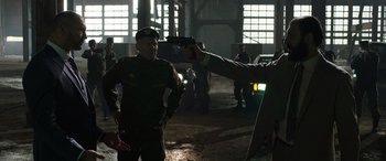 Movie still from “My Spy” (2020), directed by Peter Segal – A man holding a gun pointed at another man; Medium shot, Over the shoulder angle