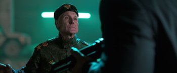 Movie still from “My Spy” (2020), directed by Peter Segal – A man in a military uniform looking at a cell phone; Close Up shot, Over the shoulder angle
