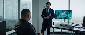 Movie still from “My Spy” (2020), directed by Peter Segal – A man in a suit talking to another man in a black shirt; Medium shot, Over the shoulder angle