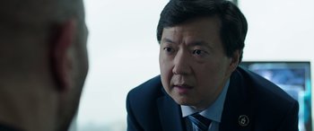 Movie still from “My Spy” (2020), directed by Peter Segal – A person wearing a suit and tie; Close Up shot, Over the shoulder angle