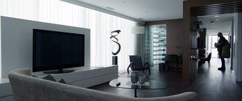 Movie still from “My Spy” (2020), directed by Peter Segal – A living room filled with furniture next to a large window; Wide shot, Low angle