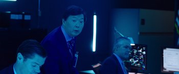 Movie still from “My Spy” (2020), directed by Peter Segal – A man in a suit and tie standing next to another man in a suit and tie; Medium shot, Over the shoulder angle