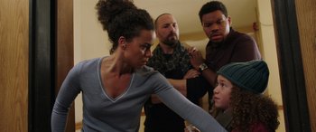 Movie still from “My Spy” (2020), directed by Peter Segal – A group of people standing in a living room; Medium shot, Low angle