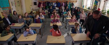 Movie still from “My Spy” (2020), directed by Peter Segal – A group of children sitting at desks in a classroom; Wide shot, High angle