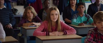 Movie still from “My Spy” (2020), directed by Peter Segal – A girl sitting in front of a group of other girls; Medium shot, Over the shoulder angle