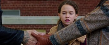 Movie still from “My Spy” (2020), directed by Peter Segal – A young girl wearing a brown sweater and brown gloves; Close Up shot, Over the shoulder angle