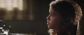 Movie still from “My Spy” (2020), directed by Peter Segal – A young girl's face in the dark; Close Up shot, Low angle