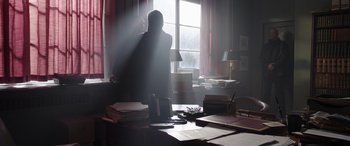 Movie still from “My Spy” (2020), directed by Peter Segal – A person standing in front of a window in a room; Wide shot, Low angle