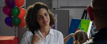 Movie still from “My Spy” (2020), directed by Peter Segal – A woman with curly brown hair is smiling; Close Up shot, Over the shoulder angle