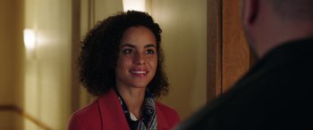 Movie still from “My Spy” (2020), directed by Peter Segal – A woman in a red jacket smiling for the camera; Close Up shot, Over the shoulder angle