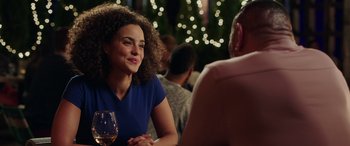 Movie still from “My Spy” (2020), directed by Peter Segal – A woman sitting at a table with a glass of wine in front of a man; Close Up shot, Over the shoulder angle