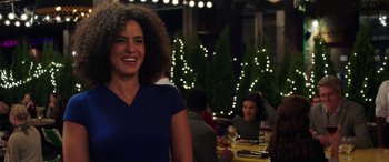 Movie still from “My Spy” (2020), directed by Peter Segal – A woman standing in front of a group of diners; Medium shot, Over the shoulder angle