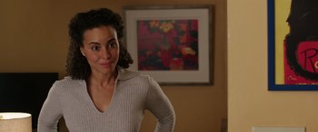 Movie still from “My Spy” (2020), directed by Peter Segal – A woman standing in front of a painting in a living room; Close Up shot, Over the shoulder angle