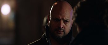 Movie still from “My Spy” (2020), directed by Peter Segal – A man with a bald head is looking at the camera; Close Up shot, Over the shoulder angle
