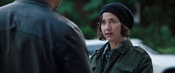 Movie still from “My Spy” (2020), directed by Peter Segal – A woman wearing a hat and a green jacket; Close Up shot, Over the shoulder angle