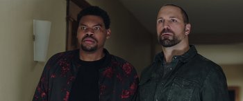 Movie still from “My Spy” (2020), directed by Peter Segal – A couple of men standing next to each other; Close Up shot, Low angle