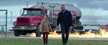 Movie still from “My Spy” (2020), directed by Peter Segal – A man and a child walking in front of a fire truck; Wide shot, Over the shoulder angle