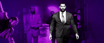 Movie still from “My Spy” (2020), directed by Peter Segal – A man in a suit and tie standing next to another man in a suit and tie; Medium shot, Low angle