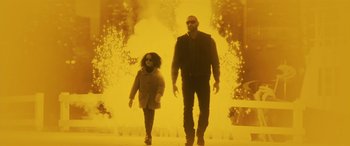 Movie still from “My Spy” (2020), directed by Peter Segal – A man and a child walking in front of a fire; Wide shot, Low angle