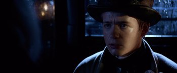 Movie still from “National Treasure” (2004), directed by Jon Turteltaub – A man in a black hat and a black jacket; Close Up shot, Over the shoulder angle