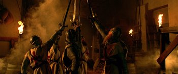 Movie still from “National Treasure” (2004), directed by Jon Turteltaub – A group of people dressed in medieval costumes holding swords; Medium shot, Low angle