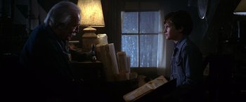 Movie still from “National Treasure” (2004), directed by Jon Turteltaub – A man sitting at a table with a woman; Medium shot, Over the shoulder angle