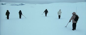 Movie still from “National Treasure” (2004), directed by Jon Turteltaub – Three skiers are walking through deep snow; Extreme Wide shot, High angle