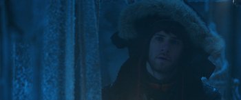 Movie still from “National Treasure” (2004), directed by Jon Turteltaub – A man wearing a fur hat in the dark; Close Up shot, Over the shoulder angle