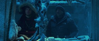 Movie still from “National Treasure” (2004), directed by Jon Turteltaub – A man sitting in front of a mirror in the snow; Medium shot, Low angle