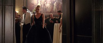 Movie still from “National Treasure” (2004), directed by Jon Turteltaub – A woman in a black dress standing in front of a man; Medium shot, Over the shoulder angle