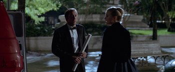 Movie still from “National Treasure” (2004), directed by Jon Turteltaub – A man and a woman in formal wear talking to each other; Medium shot, Over the shoulder angle
