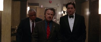 Movie still from “National Treasure” (2004), directed by Jon Turteltaub – A group of men standing next to each other in a hallway; Medium shot, Low angle