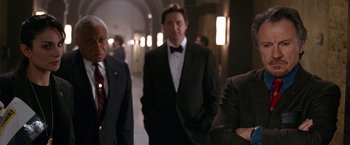 Movie still from “National Treasure” (2004), directed by Jon Turteltaub – A group of men standing next to each other in a hallway; Medium shot, Over the shoulder angle