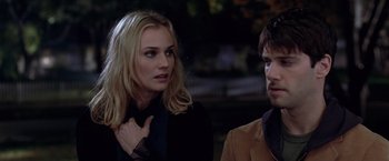 Movie still from “National Treasure” (2004), directed by Jon Turteltaub – A woman standing next to a man wearing a suit; Close Up shot, Over the shoulder angle