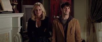 Movie still from “National Treasure” (2004), directed by Jon Turteltaub – A man and a woman standing next to each other; Medium shot, Over the shoulder angle