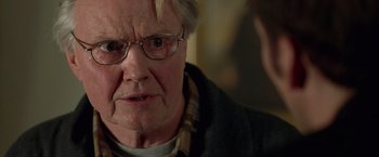 Movie still from “National Treasure” (2004), directed by Jon Turteltaub – An old man with glasses is looking at the camera; Close Up shot, Over the shoulder angle