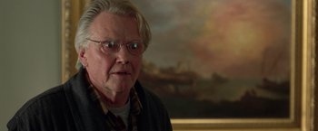 Movie still from “National Treasure” (2004), directed by Jon Turteltaub – An older man with glasses is looking at the camera; Close Up shot, Over the shoulder angle