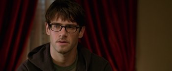 Movie still from “National Treasure” (2004), directed by Jon Turteltaub – A person wearing glasses; Close Up shot, Over the shoulder angle